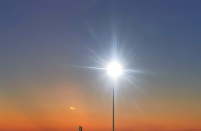 There is a Light that Never Goes Out - A musing by Graham Lawrence. The picture shows a light in front of a sunset.
