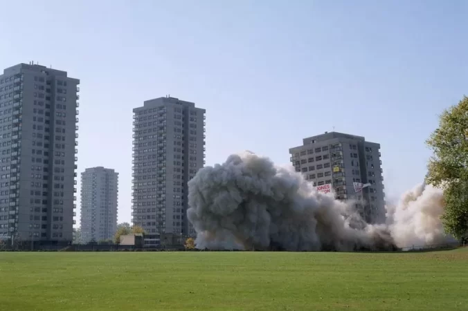 The End - A memoir piece by Graham Lawrence. The picture shows the demolition of a tower block in Trowbridge Estate, Hackney Wick, London